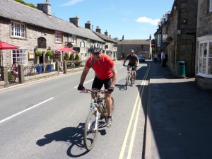 Steve and Peter riding through Castleton.        